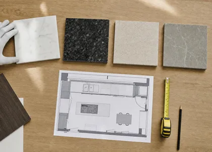 Muestras de encimera, plano de cocina en planta y cinta métrica sobre una mesa (imagen ilustrativa)